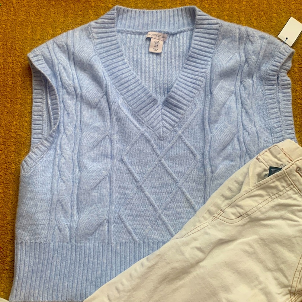 This is a beautiful baby blue sweater vest that anyone could look great in!